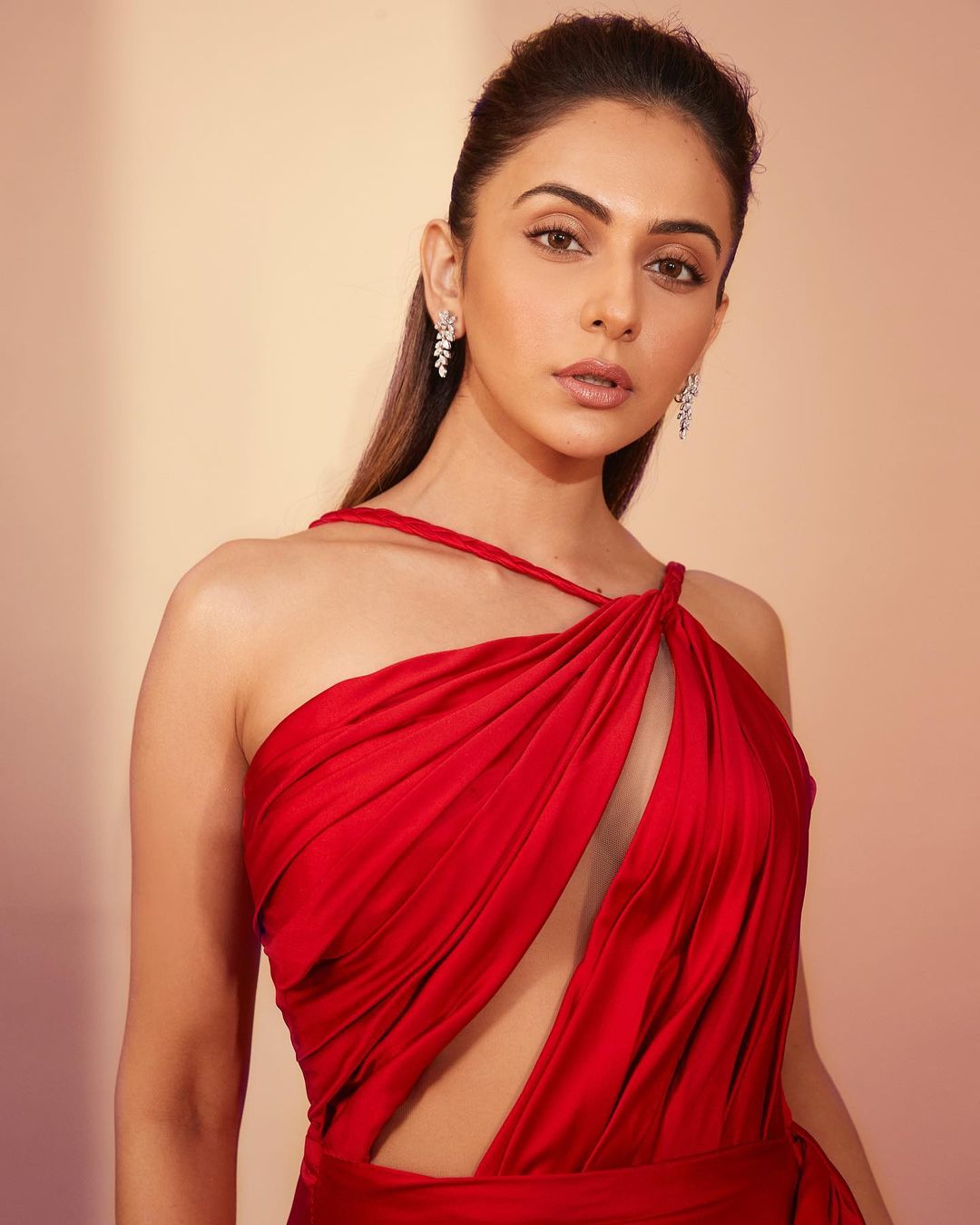 Alluring Poses Of Rakul in Red Outfit